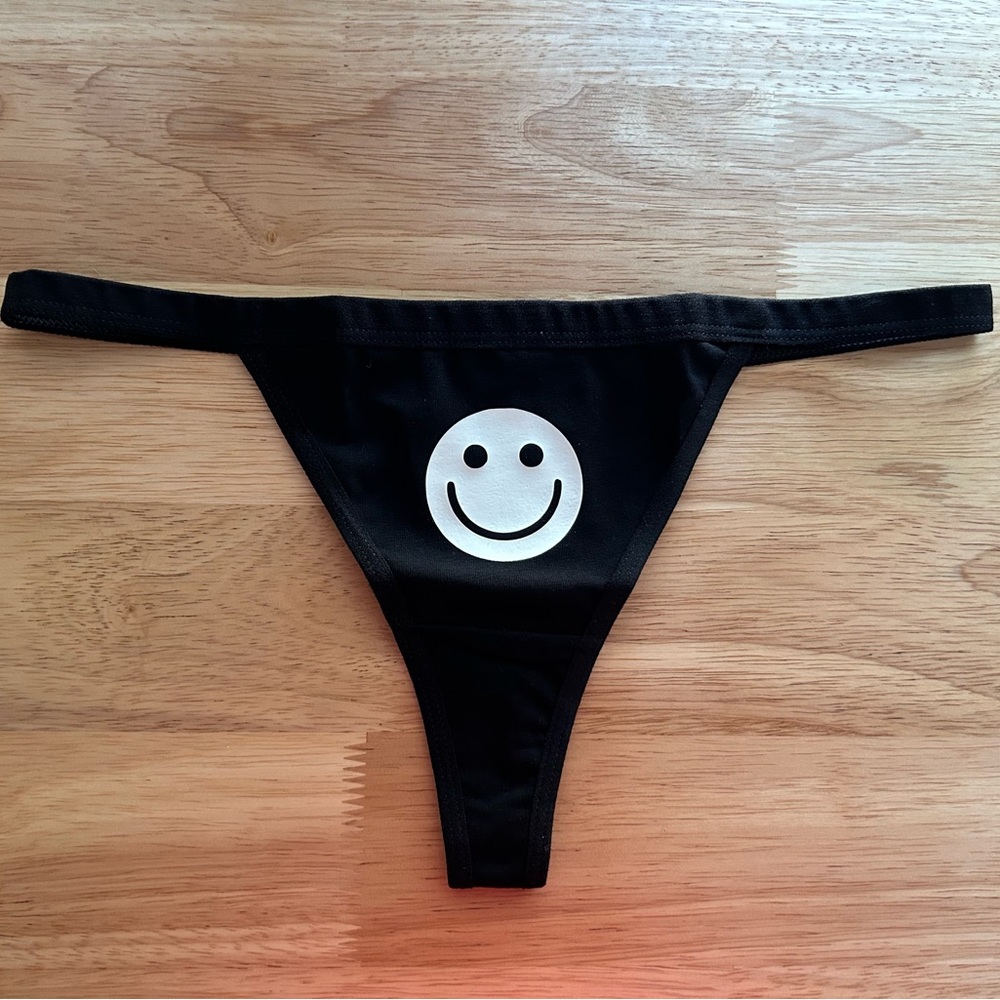 NWOT Sexy Black Thong Underwear with White Glow in the Dark Happy Face Print